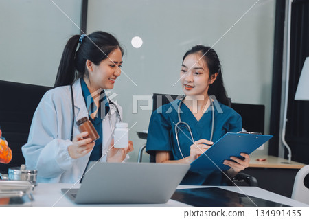 Medical, meeting and laptop for team in office in discussion, brainstorming and planning. Doctor, nurse and computer on desk, teamwork or workshop for Model Internal organ. 134991455