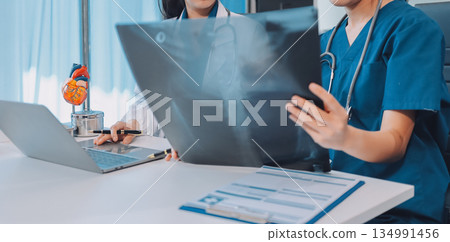 Medical, meeting and laptop for team in office in discussion, brainstorming and planning. Doctor, nurse and computer on desk, teamwork or workshop for Model Internal organ. 134991456