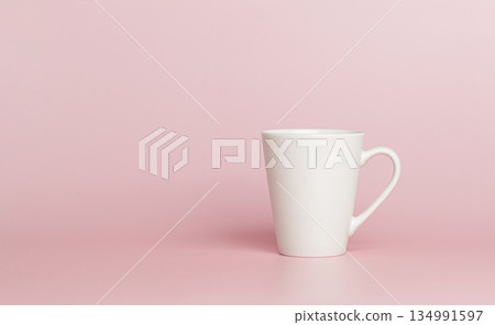 white cup for tea or coffee on a pink background white cup for tea or coffee on a pink background 134991597
