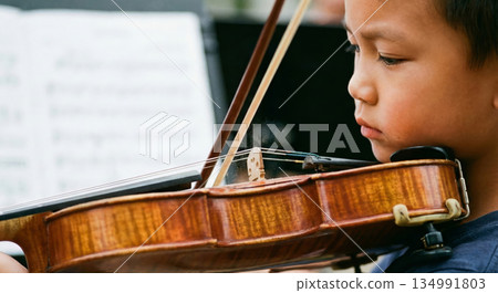 Boy Plays Violin in Closeup 134991803