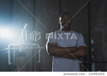 Fitness workout in gym. Portrait of African American man standing in gym with motivation health energy ready for training. Athletic coach personal trainer fitness club owner. Healthy lifestyle Fitness workout in gym. Portrait of African American man standing in gym with motivation health energy ready for training. Athletic coach personal trainer fitness club owner. Healthy lifestyle 134991930