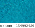 Ripples reflecting in an outdoor swimming pool, summer holiday background 134992489