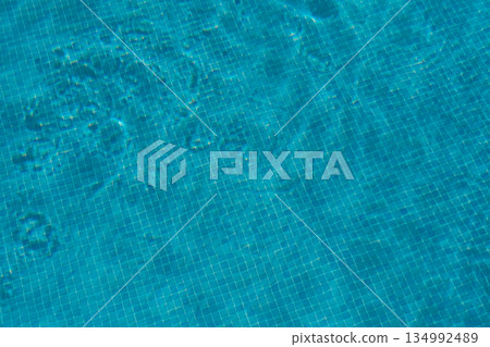 Ripples reflecting in an outdoor swimming pool, summer holiday background 134992489