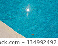 Bright sunlight reflects on clean pool water, summer mood background 134992492