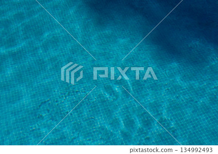 Swimming pool bottom with blue tiled texture, summer mood background Swimming pool bottom with blue tiled texture, summer mood background 134992493