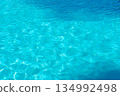 Swimming pool water shimmers in the sunlight, summer background 134992498