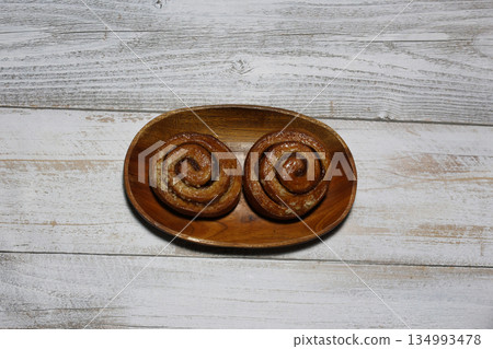 Cinnamon rolls on wood background Cinnamon rolls on wood background 134993478