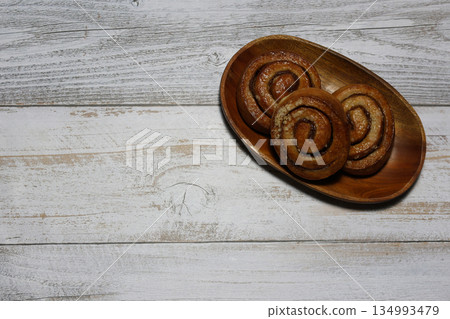 Cinnamon rolls on wood background Cinnamon rolls on wood background 134993479