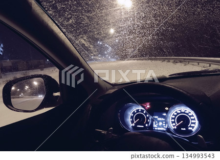 Car Windshield Covered With Frost On The Roadside At Night Car Windshield Covered With Frost On The Roadside At Night 134993543