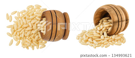 Shelled European pine nuts in wooden bowl isolated on white background with full depth of field. Top view. Flat lay Shelled European pine nuts in wooden bowl isolated on white background with full depth of field. Top view. Flat lay 134993621