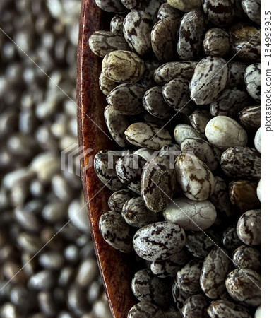 Macro Close-Up of Chia Seeds on Wooden Spoon Healthy Superfood Texture Macro Close-Up of Chia Seeds on Wooden Spoon Healthy Superfood Texture 134993915