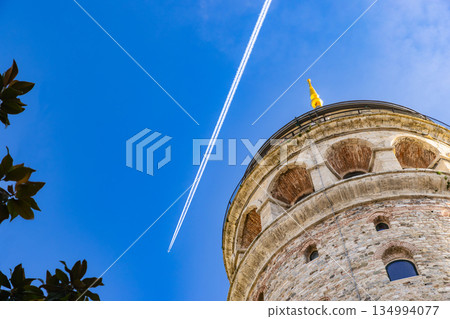 Galata Tower and contrails in Istanbul, Turkey 134994077