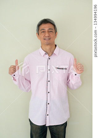 Man making a like hand sign indoors Man making a like hand sign indoors 134994196