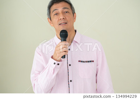 A man who speaks with a microphone A man who speaks with a microphone 134994229