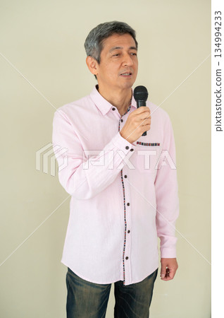 A man who speaks with a microphone A man who speaks with a microphone 134994233