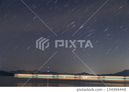 Spring starry scenery in the Setouchi Inland Sea: Star trails in the beautiful sky over the many islands Spring starry scenery in the Setouchi Inland Sea: Star trails in the beautiful sky over the many islands 134994448