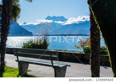 Montreux lakeside promenade with autumn trees and benches. Montreux, Vaud, Switzerland Montreux lakeside promenade with autumn trees and benches. Montreux, Vaud, Switzerland 134994920