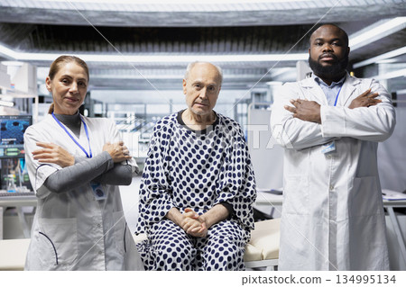 Portrait of diverse researchers and old man posing in modern laboratory, working together on a clinical trial and testing a new drug for breakthrough in healthcare prevention. Portrait of diverse researchers and old man posing in modern laboratory, working together on a clinical trial and testing a new drug for breakthrough in healthcare prevention. 134995134