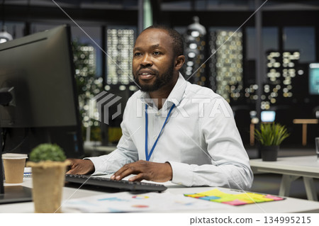 African american consultant engaged in planning and analysis with computer results to create strategy reports for shareholders. Working on innovation, objectives alignment and growth. African american consultant engaged in planning and analysis with computer results to create strategy reports for shareholders. Working on innovation, objectives alignment and growth. 134995215