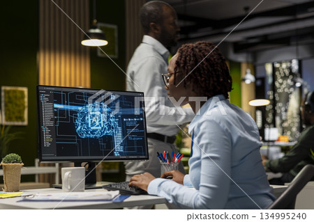 African american woman pleased with AI integration success for efficiency recognition, using a synergy of data sharing and optimization models in a co working space. Progress prosperity. 134995240