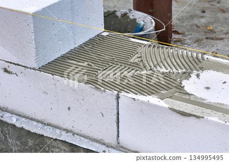 Traces of trowel for laying cement on aerated concrete,expanded clay blocks 134995495