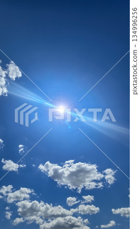 Vast blue sky filled with soft white clouds inspires calm, clarity, and a sense of freedom. Perfect for nature, travel, outdoor, wellness, and inspirational stock imagery. Vast blue sky filled with soft white clouds inspires calm, clarity, and a sense of freedom. Perfect for nature, travel, outdoor, wellness, and inspirational stock imagery. 134996256