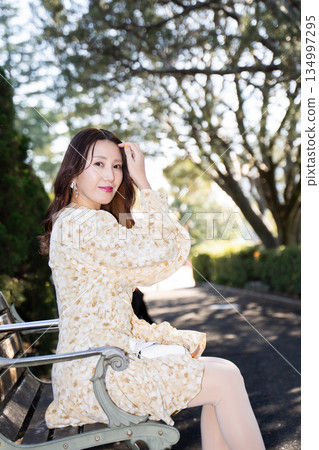A woman sitting on a bench A woman sitting on a bench 134997295