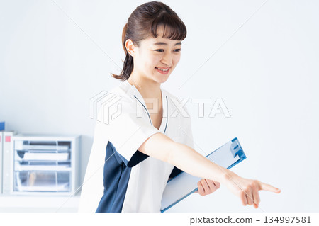 Female nurse holding a file Female nurse holding a file 134997581