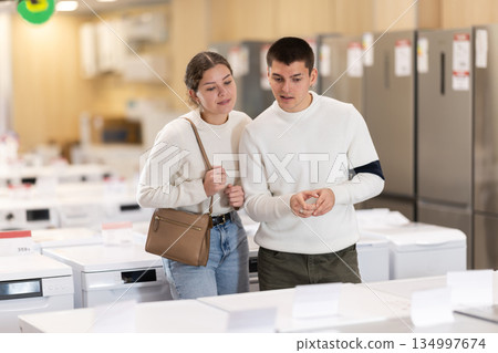 Man and a woman choose household appliances in store 134997674