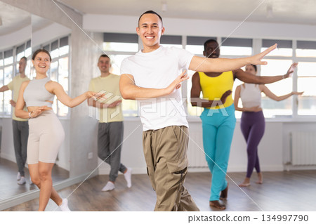 European guy with team of like-minded multinational people learn to elements of hip hop dance European guy with team of like-minded multinational people learn to elements of hip hop dance 134997790