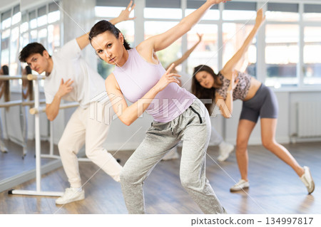 Woman honing hip-hop dance moves in choreographic studio Woman honing hip-hop dance moves in choreographic studio 134997817