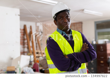 Confident african american engineer standing n building under renovation 134997822