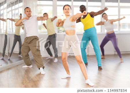 Smiling young girl enjoying vigorous dance at group class Smiling young girl enjoying vigorous dance at group class 134997834