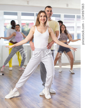 Couple male and girl rehearsing pair latino dance in modern dance studio 134997863