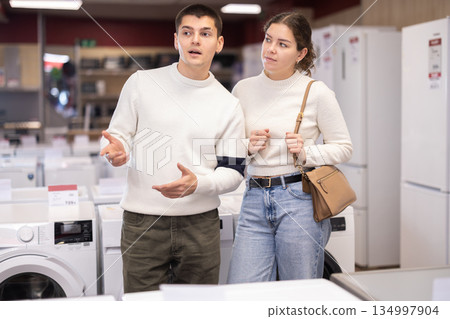 Young couple choosing washing machine or dishwasher 134997904
