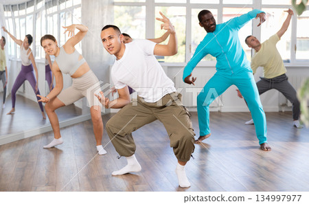 European guy with team of like-minded multinational people learn to elements of hip hop dance European guy with team of like-minded multinational people learn to elements of hip hop dance 134997977