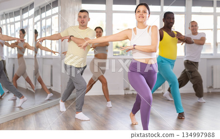 Young Asian woman practicing rhythmic aerobics at group workout Young Asian woman practicing rhythmic aerobics at group workout 134997988