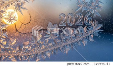 Sparkling 2026 numbers with golden frost patterns on winter glass surface during sunrise morning light creating magical ice crystals and bokeh effects 134998017