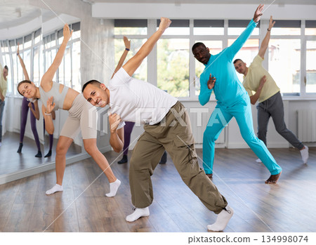 European guy with team of like-minded multinational people learn to elements of hip hop dance European guy with team of like-minded multinational people learn to elements of hip hop dance 134998074