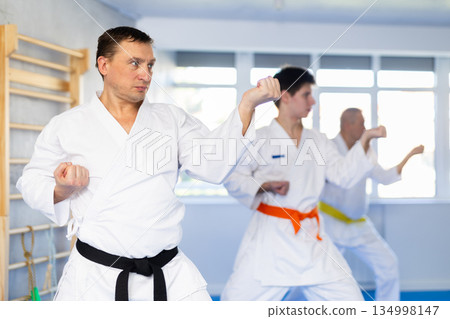 Adult man training karate technique in studio 134998147