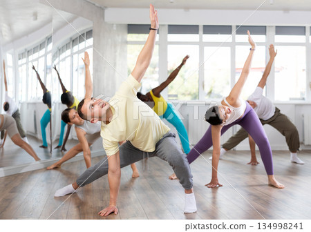 Young man doing leg exercises in training hall 134998241