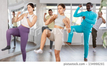 Young woman practicing Capoeira dance in training hall 134998281