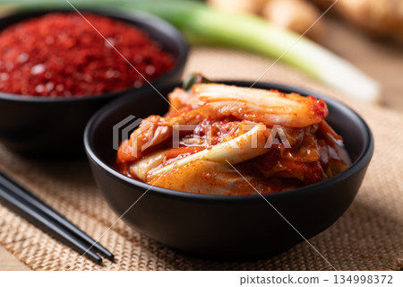Kimchi cabbage in a bowl with ingredients, Korean food 134998372