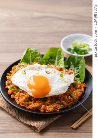 Korean kimchi fried rice with fried egg and spring onion on top Korean kimchi fried rice with fried egg and spring onion on top 134998378