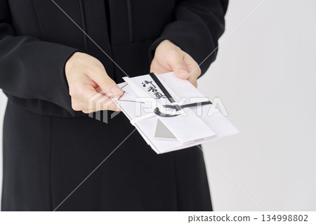 A woman in mourning clothes giving a condolence gift, white background, no face A woman in mourning clothes giving a condolence gift, white background, no face 134998802