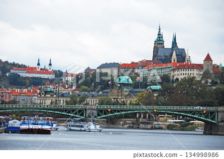 Prague Castle and St. Vitus Cathedral seen from downstream of the Čech Bridge over the Vltava River in Prague, the capital of the Czech Republic 134998986