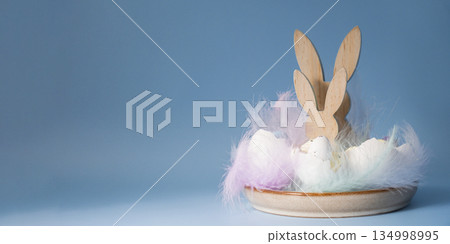Creative handmade Easter table decoration with egg shells bunny and eggs instruction on pastel blue background copy space. Greeting card idea Easter home tradition Seasonal sustainable recycled Creative handmade Easter table decoration with egg shells bunny and eggs instruction on pastel blue background copy space. Greeting card idea Easter home tradition Seasonal sustainable recycled 134998995
