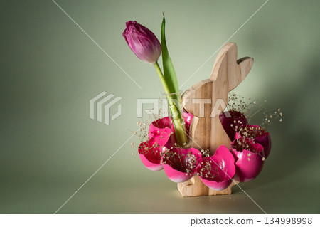 Self made vibrant pink egg shell with wooden bunny vase handmade decoration for Easter holiday. Copy space greeting card present gift ideas. Tulip flower Creative reuse zero waste sustainable living 134998998