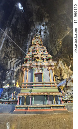 A vibrant Hindu temple bursts with color and sacred detail inside a cave 134999130