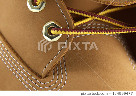 Close-Up Of Tan Hiking Boot Eyelets And Laces With Detailed Stitching Close-Up Of Tan Hiking Boot Eyelets And Laces With Detailed Stitching 134999477